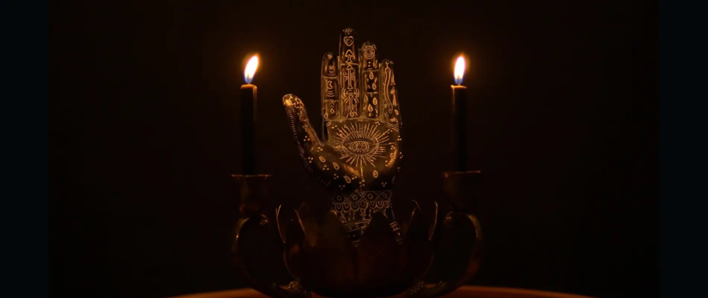 A mystical hand radiates with a golden aura, bathed in a soft, celestial light. The creases and lines on the palm reveal the secrets of the universe, a window into the soul. The fingers, delicately positioned, guide the viewer through the ancient art of palmistry, inviting them to explore the depths of self-discovery. The scene is captured in a symmetrical, realistic composition, free from distortion, allowing the intricacies of the hand to shine. This captivating image, a testament to the timeless wisdom of palmistry, beckons the viewer to unveil the hidden messages written upon the palm.